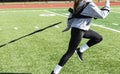 Female teenager pulling a weighted sled at practice Royalty Free Stock Photo