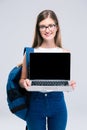 Female teenager showing blank laptop computer screen Royalty Free Stock Photo