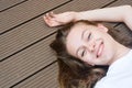 Female teenager smiling, layingon the floor. Summer, portrait of young girl with long, blonde hair Royalty Free Stock Photo