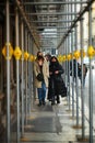 Female teenagers walk downtown wearing mandatory protective mask