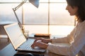 Female teleworker texting using laptop and internet, working online. Freelancer typing at home office, workplace. Royalty Free Stock Photo