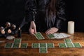 Female tells the future with playing cards. Tarot card concept on the table. Prediction of the future. Fortuneteller hands in Royalty Free Stock Photo
