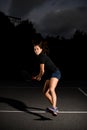 Female tennis player with brown f hair waiting tennis ball. Outdoor tennis practice.