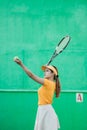 Female tennis player concentrating on serving holding ball with racket Royalty Free Stock Photo
