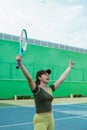 female tennis player in hand gesture symbol of victory