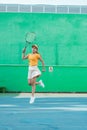 Female tennis player moving in jumping after hitting ball Royalty Free Stock Photo