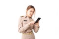 Female Thai government officer in khaki uniforms smiling and standing typing smartphone on white background. Cheerful beautiful