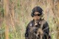 Female Thai soldier communicating with walkie-talkie during field training