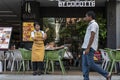 a female Thai waitress looks with interest at a passing dark man. thailand, Phuket, December 31, 2019