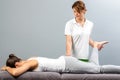 Female therapist doing osteopathic leg manipulation on patient. Royalty Free Stock Photo