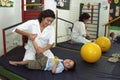 Female Therapist works with handicapped child, Brazil