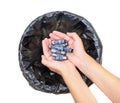 Female throwing dead corroded batteries in a waste bin