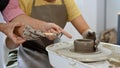 Female to making a ceramic cup on potter`s wheel. Hands moulding clay cropped image Royalty Free Stock Photo