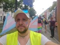 Female to male Transgender with Trans flags at pride parade in Vienna and Trans symbol on his cheeks