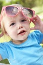 Female Toddler Trying To Put On Sunglasses Royalty Free Stock Photo