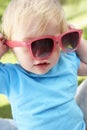 Female Toddler Trying To Put On Sunglasses Royalty Free Stock Photo