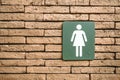 Female toilet symbols on red brick walls