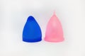 Two colorful, pink and blue sizes of menstural cups from medical high quality silicone, 20 and 30 ml capacity