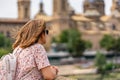 Female tourist admiring the high towers of the cathedral basilica of El Pilar in the monumental city of Zaragoza, Spain. Royalty Free Stock Photo