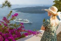 Tourist Admiring the View of the Cruise Ship Off the Coast of Santorini Greece