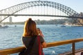 Female tourist with backpack bag taking photos of Sydney Harbour Bridge Royalty Free Stock Photo