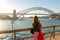 Female tourist with backpack bag taking photos of Sydney Harbour Bridge Royalty Free Stock Photo