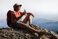 Female tourist in mountains with a bottle of drinking water Royalty Free Stock Photo