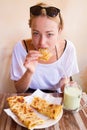 Woman eating traditional moroccan breakfast in coffee shop.