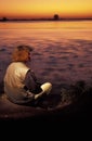 Female tourist enjoying the African sunset over river Chobe, Bot