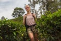 Female tourist enjoying beautiful nature of tea plantations, Sri Lanka.