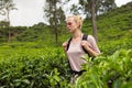 Female tourist enjoying beautiful nature of tea plantations, Sri Lanka.