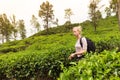 Female tourist enjoying beautiful nature of tea plantations, Sri Lanka.