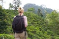 Female tourist enjoying beautiful nature of tea plantations, Sri Lanka.