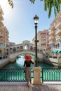 Female tourist enjoys the view to the Qanat Quartier on the Pearl in Doha Royalty Free Stock Photo