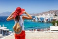 Female tourist enjoys the view to the town of Mykonos island, Greece Royalty Free Stock Photo