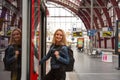 Female tourist enters the train on railway station