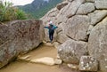 Female tourist exploring the ancient Inca ruins of Machu Picchu citadel in Cusco region, Archaeological site of Peru Royalty Free Stock Photo