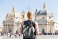 Female tourist with a fashinable vintage hipster backpack on Piazza del Popolo in Rome, Italy. Royalty Free Stock Photo