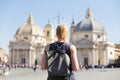 Female tourist with a fashinable vintage hipster backpack on Piazza del Popolo in Rome, Italy. Royalty Free Stock Photo