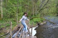 The female tourist with fear is installed on the whrough the river Red. Kaliningrad region