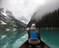 Female tourist admires the view of Lake Louise from a kayak