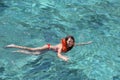 Female tourist learning to swim using a lifejacket