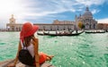 Female tourist looking the Basilica di Santa Maria della Salute and Canale Grande in Venice, Italy