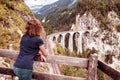 Female tourist looks at Landwasser Viaduct in Switzerland