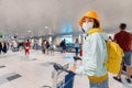 Tourist with medical protective antiviral mask with cargo cart at Domodedovo airport with Luggage