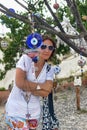 Female tourist near the amulets on the tree