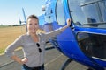 Female tourist next to helicopter Royalty Free Stock Photo