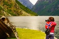 Tourist with camera near old viking boat, Norway Royalty Free Stock Photo