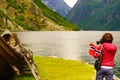 Tourist with camera near old viking boat, Norway Royalty Free Stock Photo