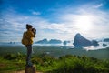 Female tourist photographers travel on the mountain. Landscape Beautiful Mountain on sea at Samet Nangshe Viewpoint. Phang Nga Bay Royalty Free Stock Photo